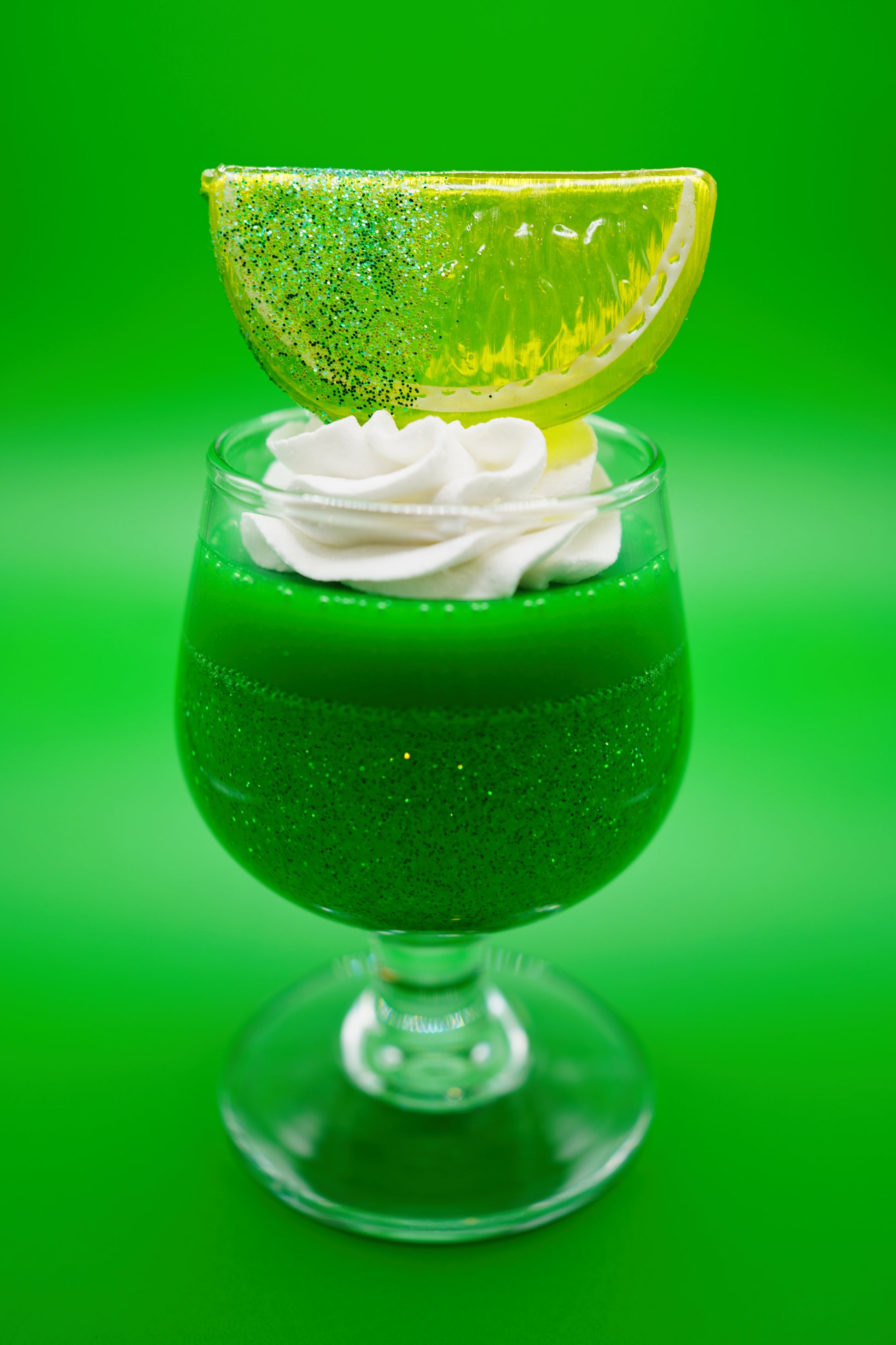 Small Green Glitter Lime Cup Jello with Fruit on top in a vintage glass