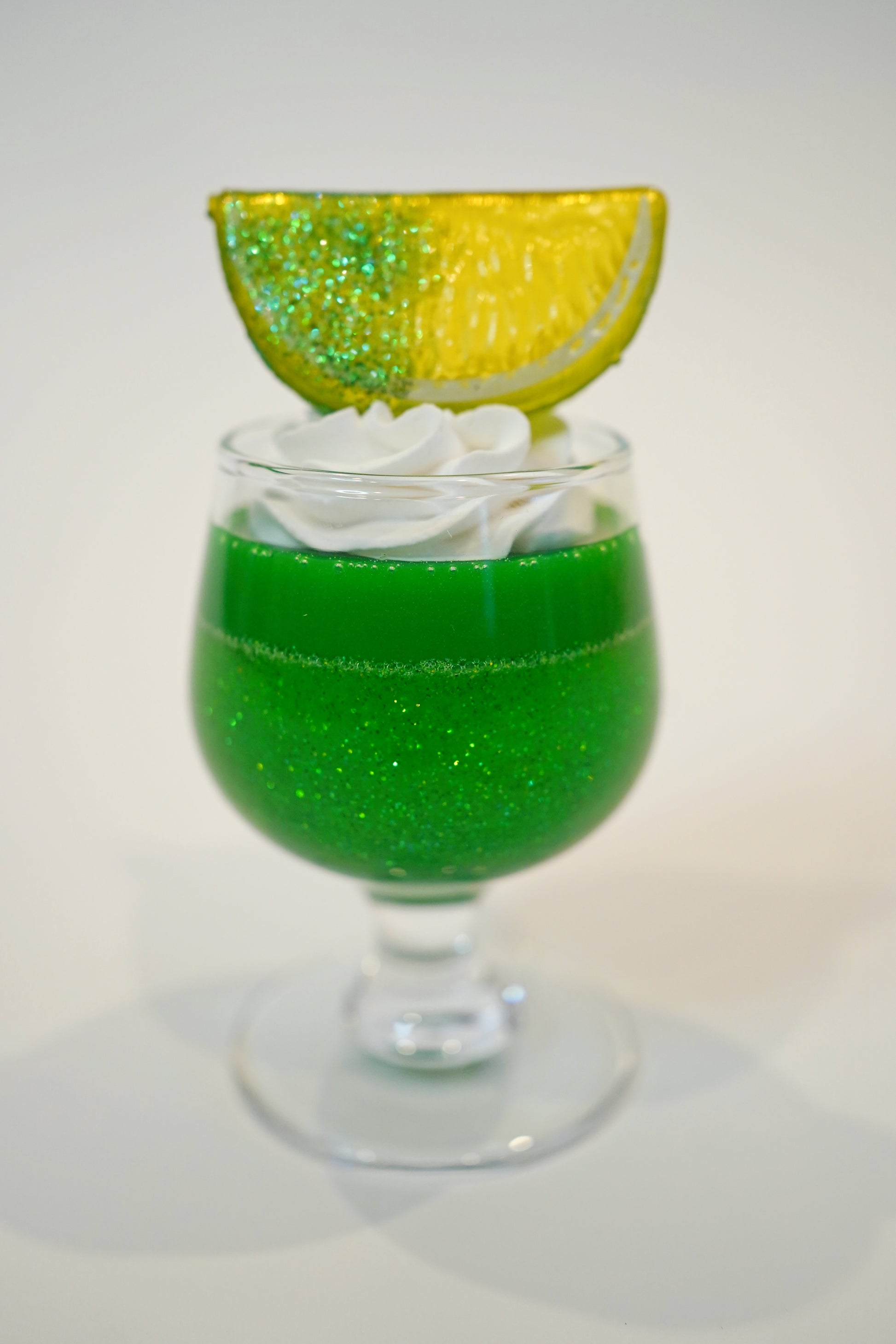 Small Green Glitter Lime Cup Jello with Fruit on top in a vintage glass